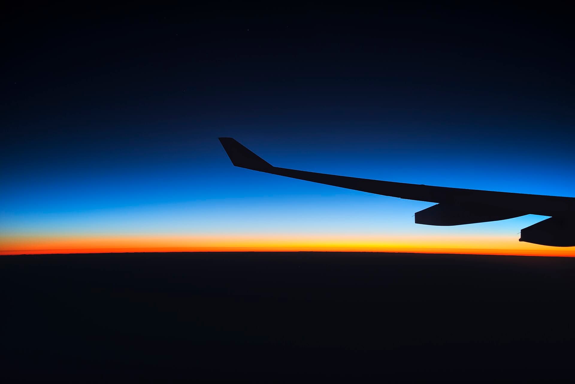 Sunrise seen through an aircraft window on an overnight flight