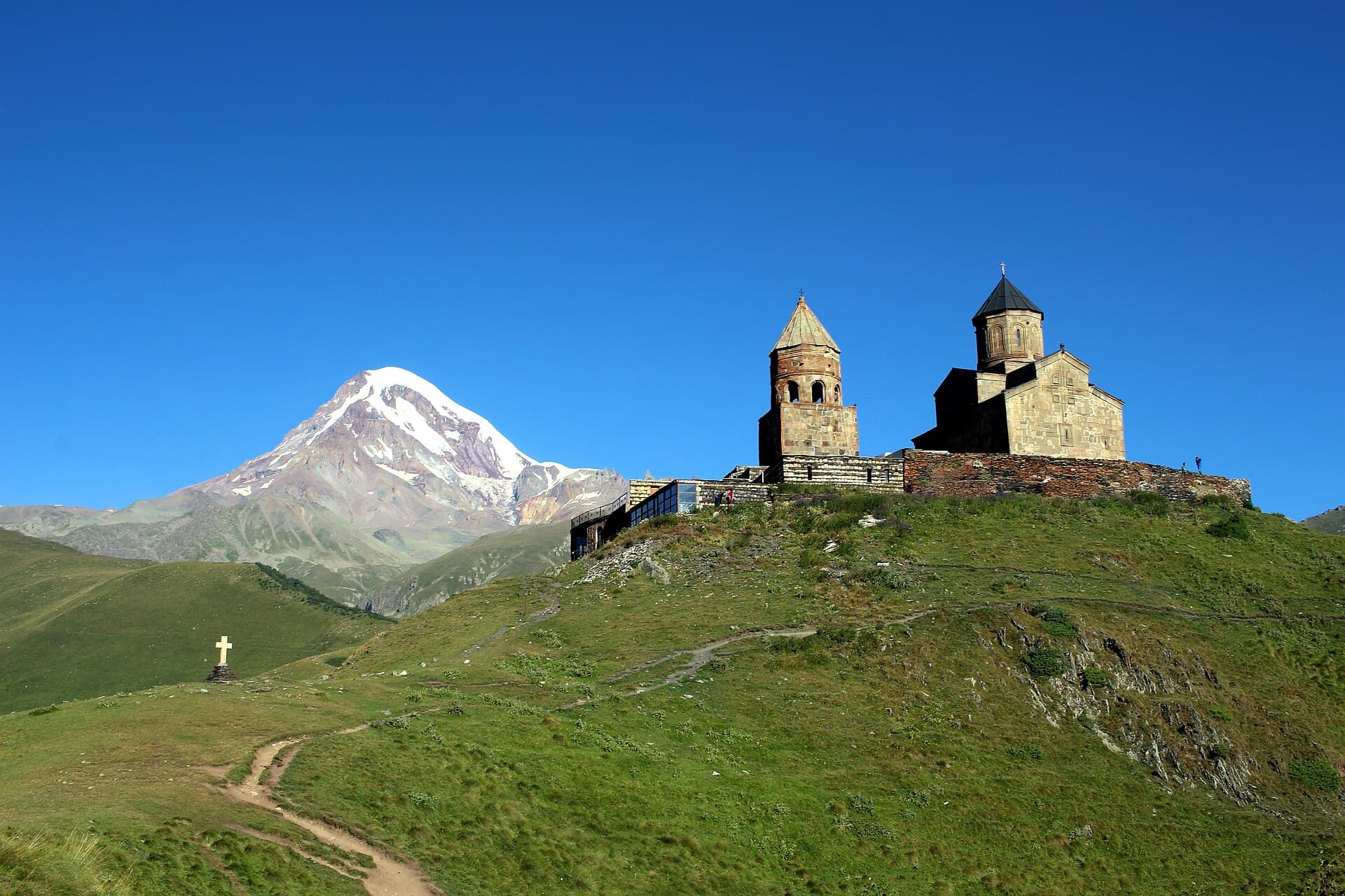Gergeti Trinity Church on a hilltop with snow-capped Mount Kazbek behind, Georgia